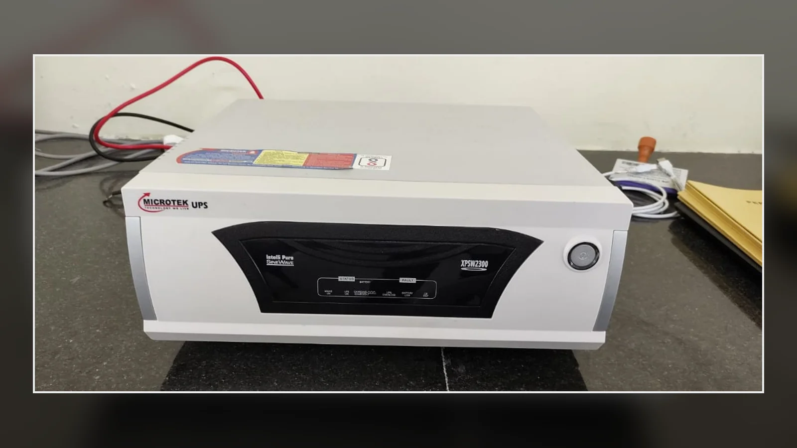 A standalone uninterruptible power supply photographed on a workbench.